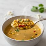 Spoon lifting Mexican Street Corn Soup close-up