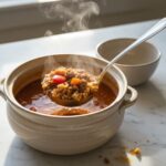 Ladling High Protein Stuffed Pepper Soup into a bowl.