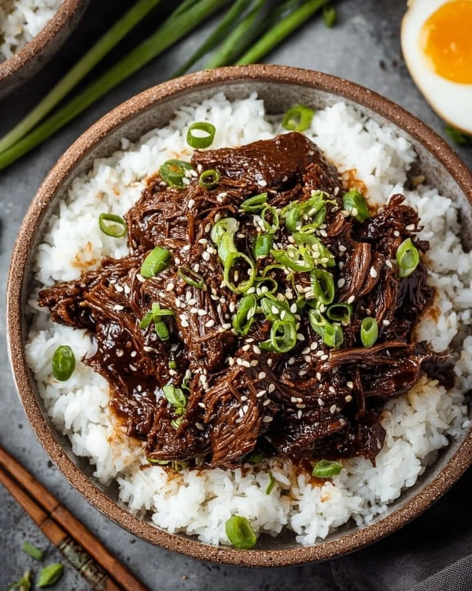 Delicious Slow Cooker Korean Beef served with rice and vegetables